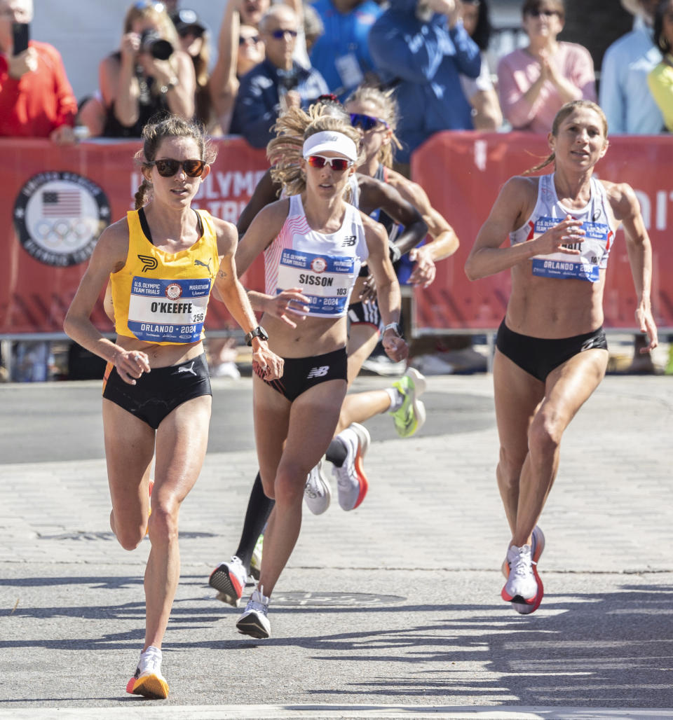 Fiona O'Keeffe, left, runs during the U.S. Olympic marathon trials in Orlando, Fla., Saturday, Feb. 3, 2024. O’Keeffe finished in a time 2 hours, 22 minutes, 10 seconds to break the American marathon trials mark of 2:25:38 set by Shalane Flanagan in 2012 in Houston. (Willie J. Allen Jr./Orlando Sentinel via AP)