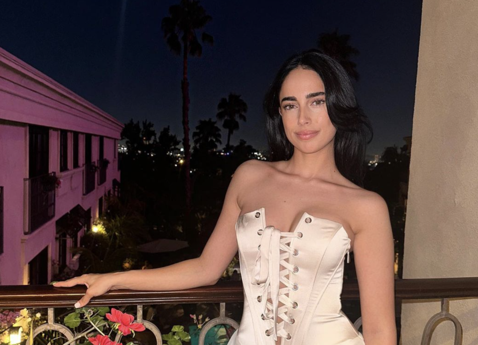 Maria Georgas wears white corset dress on Sunset Boulevard balcony. (Photo via @maria.georgas on Instagram)