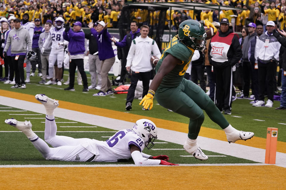 Baylor tight end Kelsey Johnson (87) scores a touchdown against TCU safety Bud Clark (26) during the first half of an NCAA college football game in Waco, Texas, Saturday, Nov. 19, 2022. (AP Photo/LM Otero)