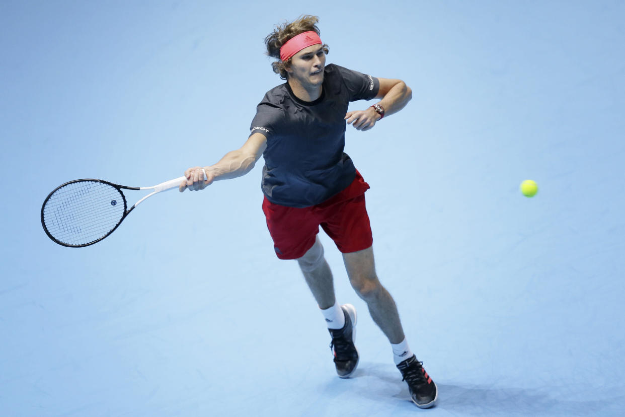 Alexander Zverev of Germany plays a return to John Isner of the United States in their ATP World Tour Finals singles tennis match at the O2 Arena in London, Friday Nov. 16, 2018. (AP Photo/Tim Ireland)