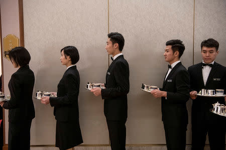 Chinese waiters and waitresses prepare to serve tea during the meeting between North Korean Foreign Minister Ri Yong Ho and China's Foreign Minister Wang Yi at the Diaoyutai State Guesthouse in Beijing December 7, 2018. Fred Dufour/Pool via REUTERS