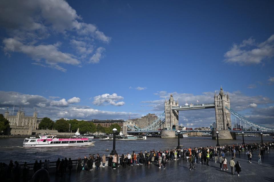 16 September 2022: Members of the public stand in the queue near Tower Bridge, and opposite the Tower of London, as they wait in line to pay their respects to the late Queen Elizabeth II, in London (AFP via Getty Images)