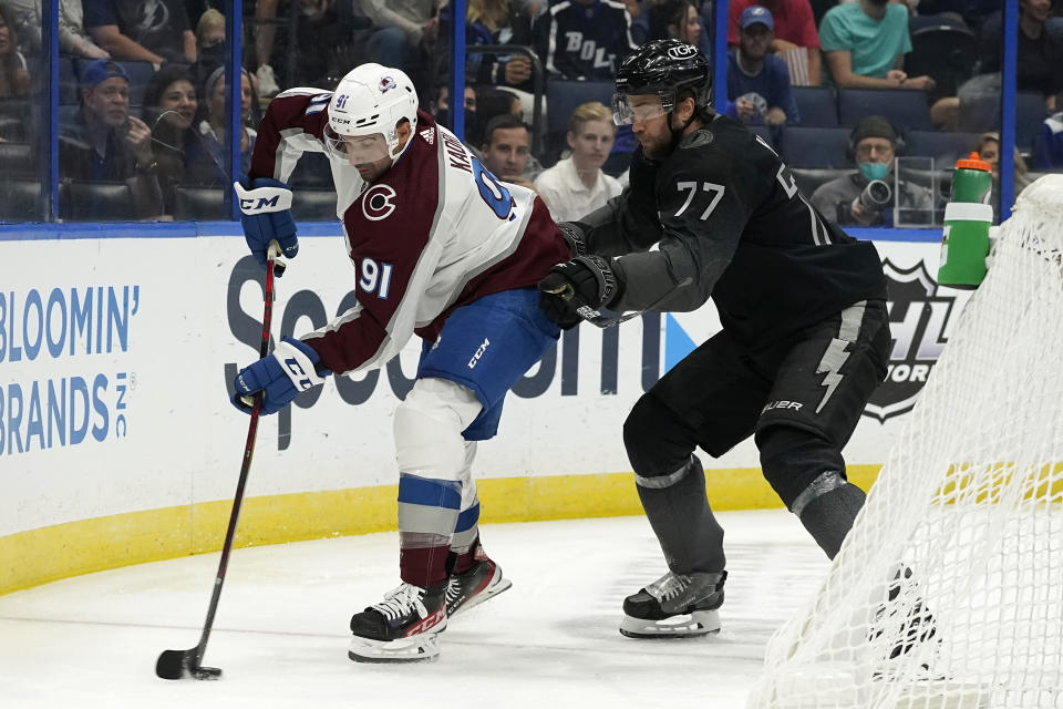 Tampa Bay Lightning defenseman Victor Hedman (77) check sColorado Avalanche center Nazem Kadri (91) as he tries to move the puck during the first period of an NHL hockey game Saturday, Oct. 23, 2021, in Tampa, Fla. (AP Photo/Chris O'Meara)