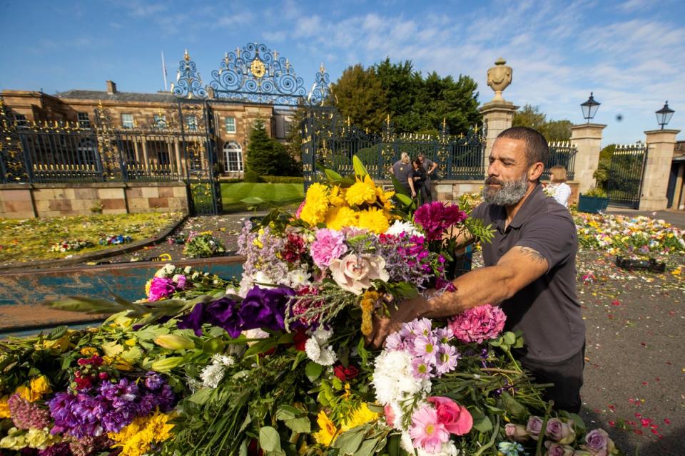 20 September 2022: Flowers which were laid by members of the public in tribute to Queen Elizabeth II at Hillsborough Castle in Northern Ireland are collected by the Hillsborough Gardening Team and volunteers to be replanted for those that can be saved or composted (PA)