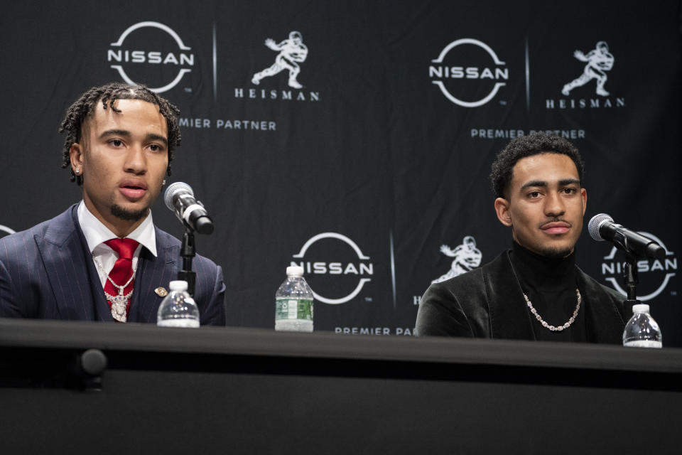 FILE - Heisman Trophy finalists Ohio State quarterback C.J. Stroud, left, speaks alongside Alabama quarterback Bryce Young during a news conference before attending the Heisman Trophy award ceremony, Saturday, Dec. 11, 2021, in New York. The Carolina Panthers packaged two first-round picks, two second-round picks and star receiver D.J. Moore to move up from No. 9 in the draft to the top pick to give Carolina the pick of the lot at quarterback in next week's draft. (AP Photo/John Minchillo, File)