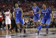 Kentucky's Aaron Harrison (2), Marcus Lee (00) and James Young, right, celebrate at the end of their 74-73 victory over Wisconsin in an NCAA Final Four tournament college basketball semifinal game Saturday, April 5, 2014, in Arlington, Texas. (AP Photo/David J. Phillip)