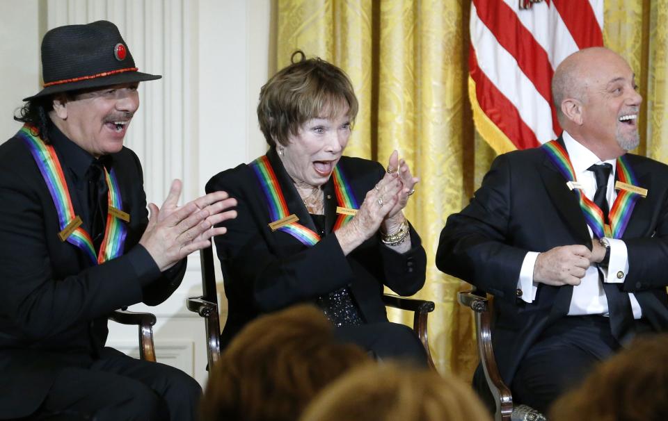 Santana and fellow 2013 Kennedy Center Honors recipients MacLaine and Joel laugh at a joke by U.S. President Obama during a reception at the White House in Washington