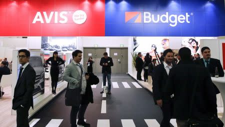 Visitors browse at the stand of Avis Budget Group vehicle rental company during the International Tourism Trade Fair (ITB) in Berlin, Germany, March 9, 2016.REUTERS/Fabrizio Bensch