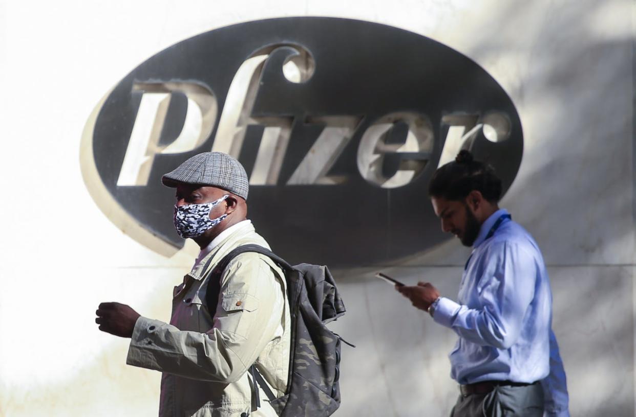 <span class="caption">Pfizer stock surged higher on Nov. 9 after the company announced its vaccine is "90% effective" against COVID-19 infections. </span> <span class="attribution"><a class="link " href="https://www.gettyimages.com/detail/news-photo/people-walk-by-the-pfizer-world-headquarters-in-new-york-on-news-photo/1229551804?adppopup=true" rel="nofollow noopener" target="_blank" data-ylk="slk:KENA BETANCUR/AFP via Getty Images;elm:context_link;itc:0;sec:content-canvas">KENA BETANCUR/AFP via Getty Images</a></span>