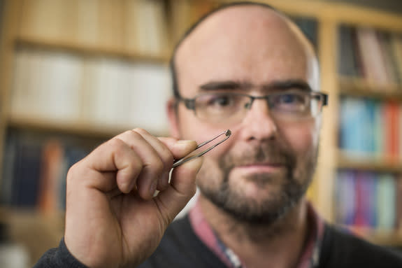 Graham Pearson holds a diamond that yields new clues about the presence of large amounts of water deep beneath the Earth.