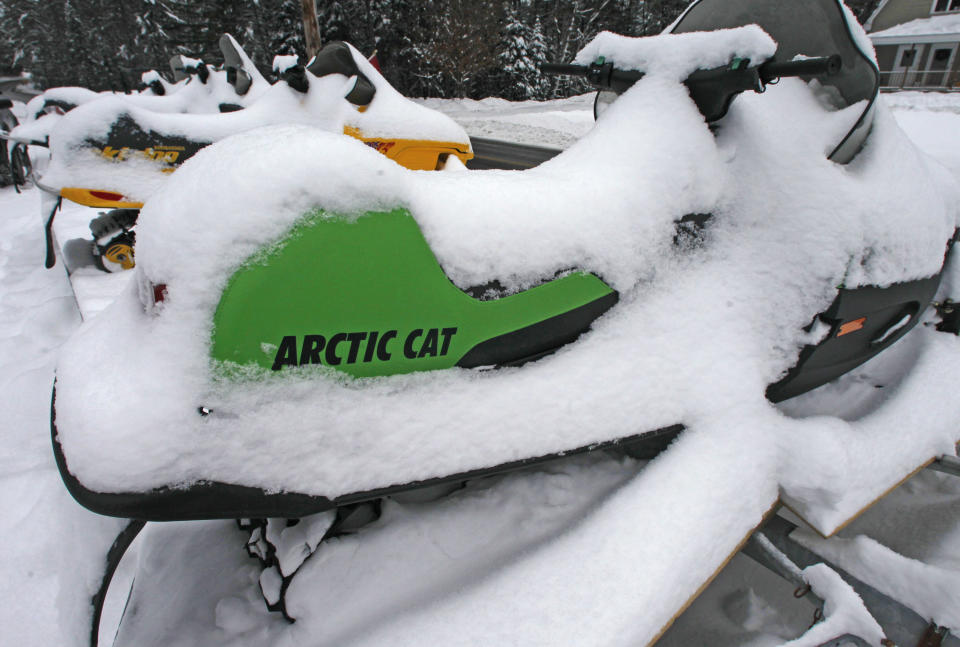 Snow covers snowmobiles for sale on Monday, Dec. 31, 2012 in East Montpelier, Vt. The big snow is giving a big boost to snowmobilers across Vermont, New Hampshire and Maine. Parts of the region have received two feet of snow and more over the last several days, giving a boost to the sport that was hampered last season by a near-snowless winter. (AP Photo/Toby Talbot)