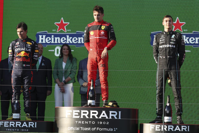 Ferrari driver Charles Leclerc, centre, of Monaco stands on the podium after winning the Australian Formula One Grand Prix in Melbourne, Australia, Sunday, April 10, 2022. Red Bull driver Sergio Perez, left, of Mexico was second and Mercedes driver George Russell of Britain finished third. (AP Photo/Asanka Brendon Ratnayake)