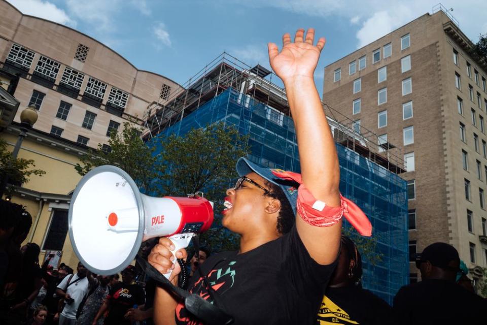 A counter-protester yells into a megaphone.