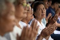 <p>Local women attend a Buddhist prayer for the missing children at a school near Tham Luang cave in Chiang Rai Province on July 1, 2018, as the rescue operation continues for a missing children’s soccer team and their coach. (Photo: Lillian Suwanrumpha/AFP/Getty Images) </p>