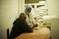 A nurse changes the bandages of a patient at Pokrovsk hospital in Pokrovsk, eastern Ukraine, Sunday, May 22, 2022. (AP Photo/Francisco Seco)