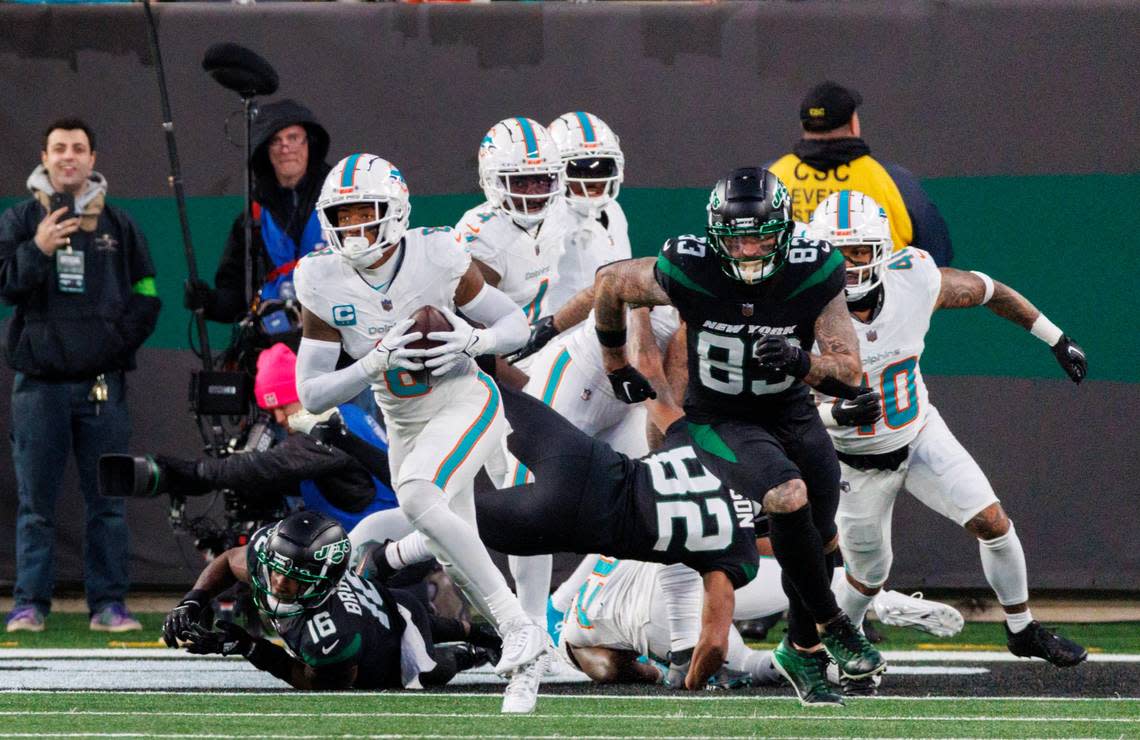 Miami Dolphins safety Jevon Holland (8) runs after intercepting a pass during second quarter of an NFL football game against the New York Jets at MetLife Stadium on Friday, Nov. 24, 2023 in East Rutherford, New Jersey.