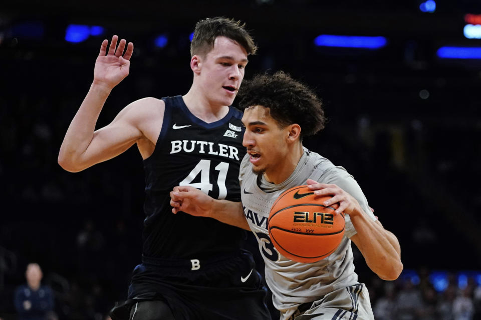 FILE -Butler's Simas Lukosius (41) defends Xavier's Colby Jones (3) during the first half of an NCAA basketball game at the Big East basketball tournament Wednesday, March 9, 2022, in New York. Xavier played its way out of NCAA Tournament consideration last year by dropping six of its last seven games before the bracket announcement. Colby Jones was named the NIT’s most outstanding player last season.(AP Photo/Frank Franklin II, File)