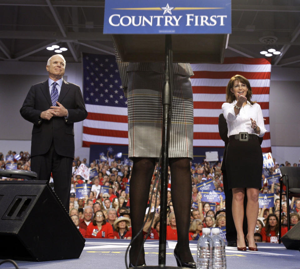 Sen. John McCain, R-Ariz., left, and his vice presidential running mate, Alaska Gov. Sarah Palin, listen as Cindy McCain, center, introduces Palin at a rally in Virginia Beach, Va., in October 2008. (Photo: Carolyn Kaster/AP)