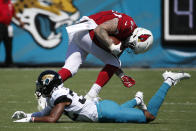 Arizona Cardinals tight end Maxx Williams, right, hurdles Jacksonville Jaguars cornerback Tyson Campbell during the first half of an NFL football game, Sunday, Sept. 26, 2021, in Jacksonville, Fla. (AP Photo/Stephen B. Morton)