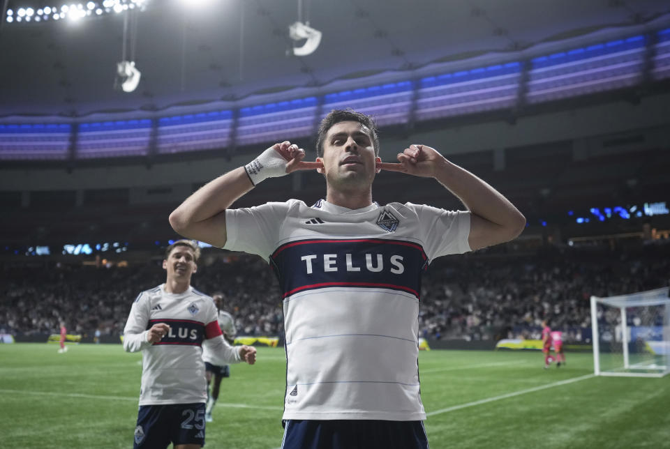 Vancouver Whitecaps' Brian White, front, celebrates his goal against St. Louis City as Ryan Gauld (25) walks over to join him during the second half of an MLS soccer match Wednesday, Oct. 4, 2023, in Vancouver, British Columbia. (Darryl Dyck/The Canadian Press via AP)