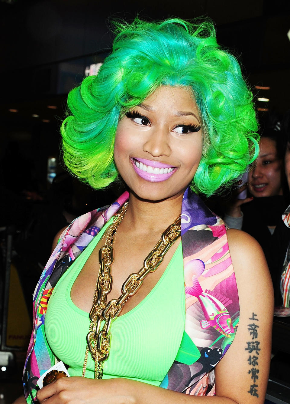 What better place than Tokyo to wear the kind of electric wig that would make Kermit proud? We're sure Minaj's was not even the most arresting style at Narita Airport that day.