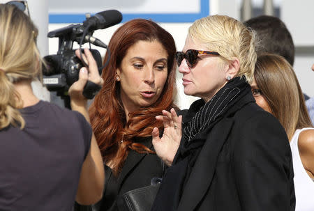 U.S. actress Ellen Barkin (R front) arrives to take a water taxi catered privately for guests attending the wedding of U.S. actor George Clooney and his fiancee Amal Alamuddin in Venice September 26, 2014. REUTERS/Alessandro Bianchi