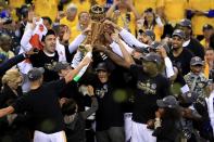 <p>The Golden State Warriors celebrate with the Larry O’Brien Championship Trophy after defeating the Cleveland Cavaliers 129-120 in Game 5 to win the 2017 NBA Finals at ORACLE Arena on June 12, 2017 in Oakland, California. </p>