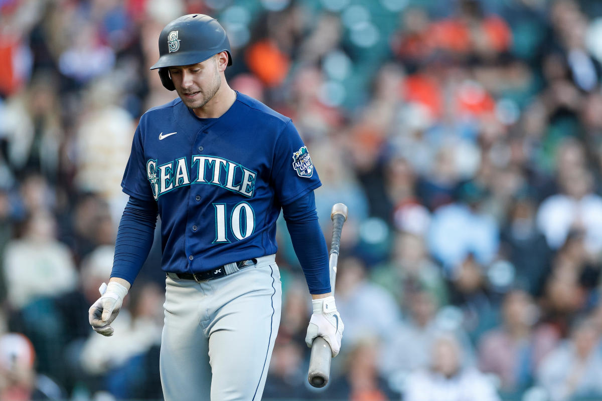 Seattle Mariners' Jarred Kelenic holds his head after a collision