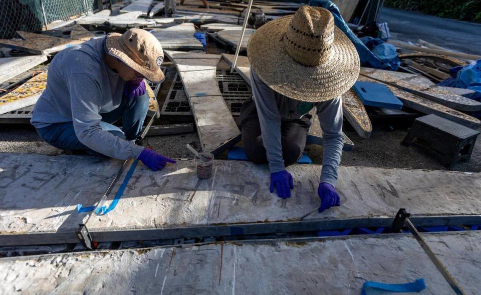 Technicians Sammi Sassi, left, and Emily Rojas of RLA Conservation work on the back of a section of a 1950s mosaic mural depicting the Greek god Apollo that is undergoing restoration at the Bakehouse Art Complex in Wynwood. The Miami Beach mural, removed and saved by preservationists in 2015 from impending destruction, will be reinstalled at a new South Beach fire station. Jose A. Iglesias/jiglesias@elnuevoherald.com