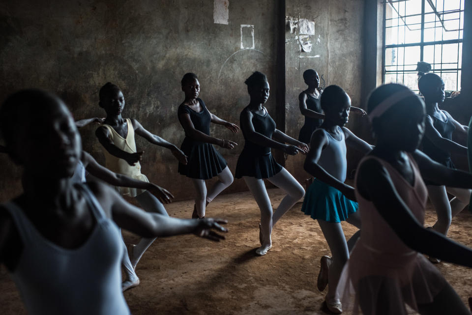 Every Wednesday at Spurgeons Academy, a school in the middle of the indecipherable maze of Kibera's narrow streets and alleys, students take the chairs and benches out of a classroom and sweep the floor. The school uniforms are switched to bright-colored clothes.<br />When teacher Mike Wamaya enters the classroom, the students get into position and place one hand on the concrete wall as though it were a ballet bar.<br />Classical music plays out of a small portable speaker, and the class begins.