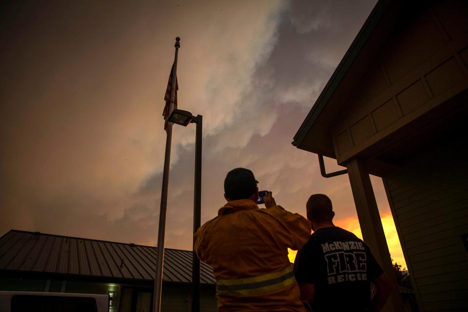 Firefighters photograph the smoke plume outside the McKenzie Fire District Station in Leaburg, Oregon on September, 8, 2020.