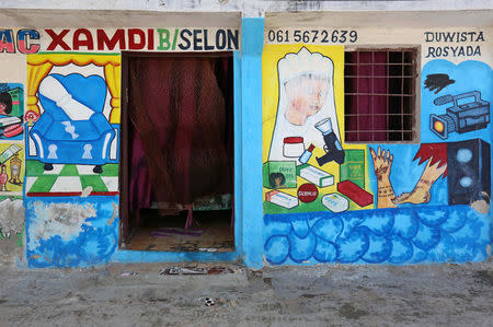 A mural on a shop front illustrates a beauty salon and traditional Somali henna in Hodan district of Mogadishu, Somalia, June 8, 2017. REUTERS/Feisal Omar