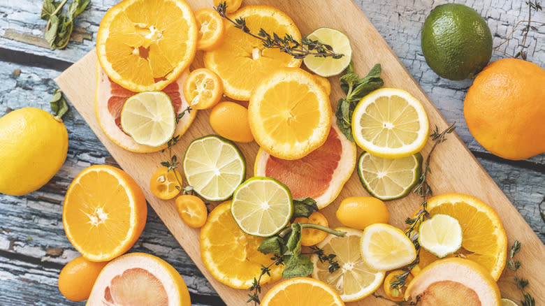 Slices of citrus fruits on a wooden board