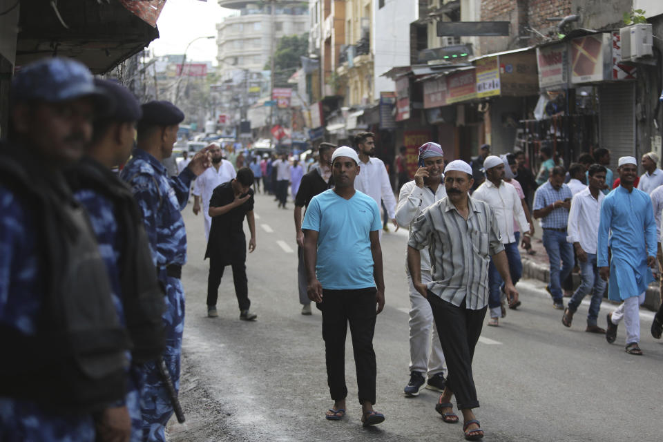 Muslims walk past Indian paramilitary soldiers after offering prayers during Eid al-Adha, or the Feast of the Sacrifice, in Jammu, India, Monday, Aug.12, 2019. An uneasy calm prevailed in Indian-administered Kashmir on Monday as people celebrated a major Islamic festival during a severe crackdown after India moved to strip the disputed region of its constitutional autonomy and imposed an indefinite curfew. (AP Photo/Channi Anand)