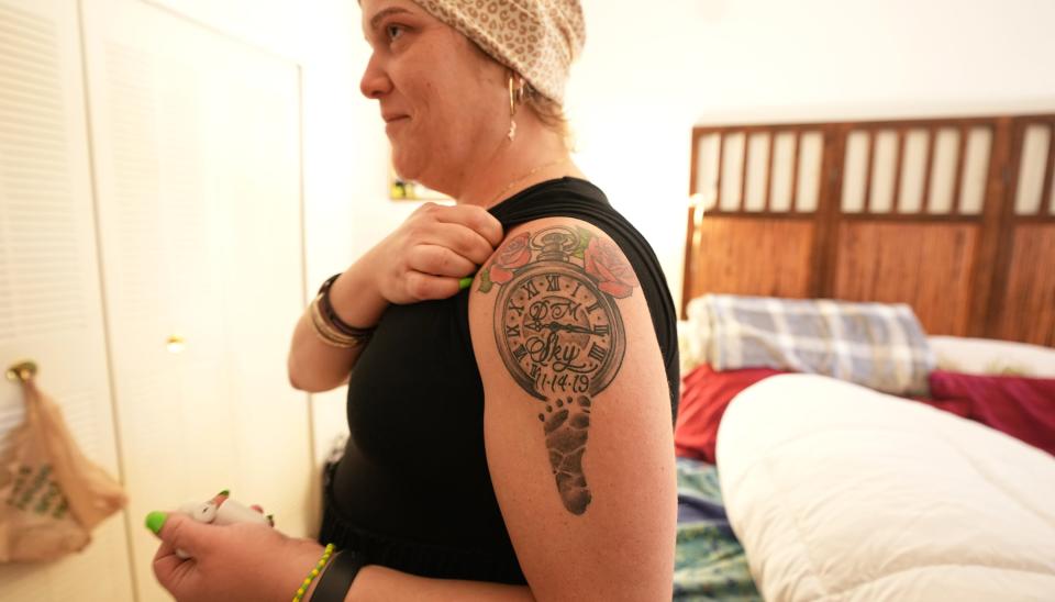 Liana Curbelo wears a tattoo of the day and time her daughter, Sky Fraser, 3, was born.