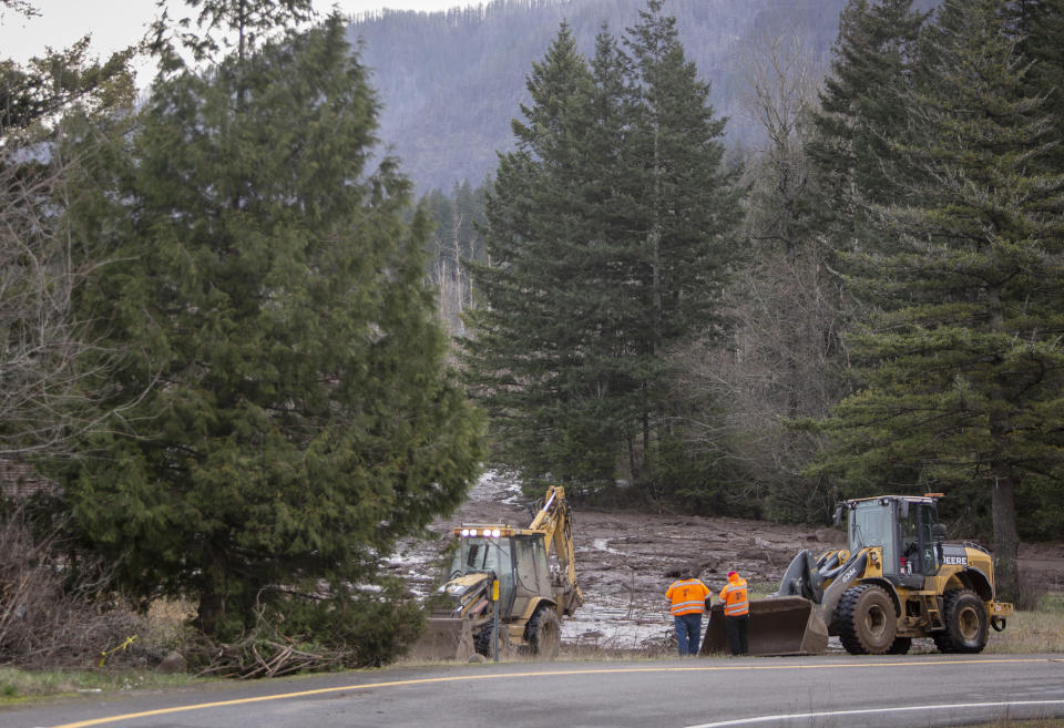 FILE - In this Thursday, Jan. 14, 2021 file photo, Search and rescue crews continue to search for a missing woman whose car was swept away by a landslide the day before in the Dodson area of the Columbia River Gorge. Sheriff’s deputies and firefighters on Saturday, Jan. 23, 2021 recovered the body of an Oregon woman whose vehicle was swept away in a deep mudslide during a winter storm last week. Jennifer Camus Moore, a registered nurse from Warrendale, Oregon, was driving in the Columbia River Gorge early Wednesday when her SUV was buried under about 15 feet of mud, rock and trees. (Brooke Herbert/The Oregonian via AP)