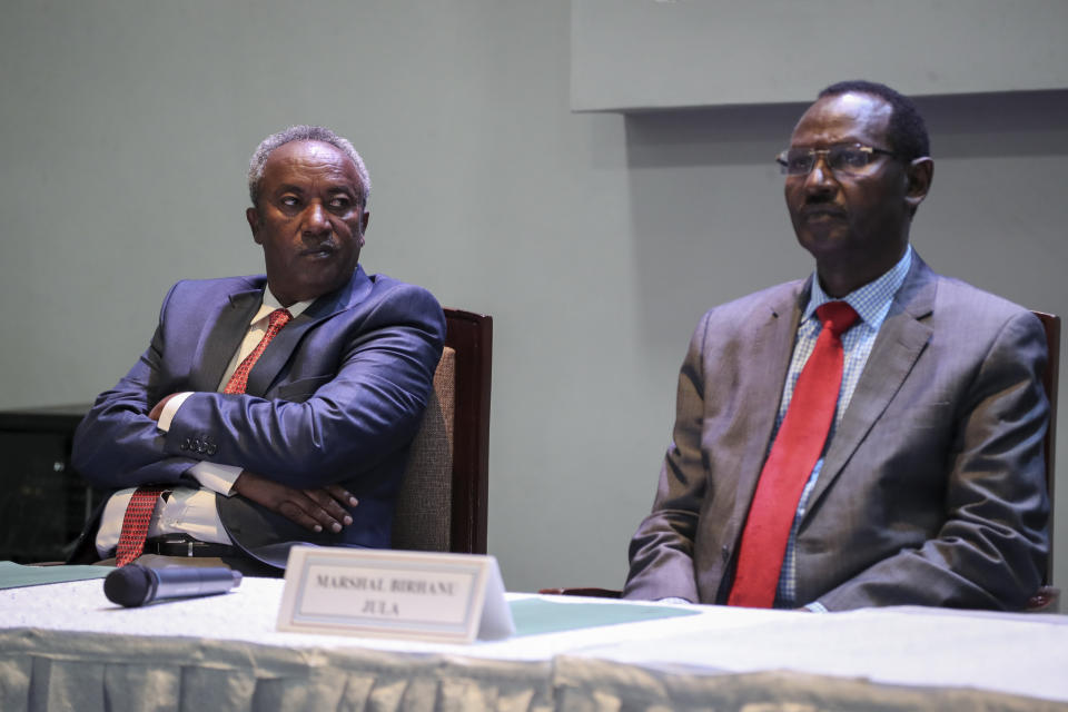 Head of the Tigray Forces Lieutenant General Tadesse Werede, left, looks across at Chief of Staff of Ethiopian Armed Forces Field Marshall Birhanu Jula, right, at Ethiopian peace talks in Nairobi, Kenya Saturday, Nov. 12, 2022. Top military commanders from Ethiopia and its embattled Tigray region agreed Saturday to allow unhindered humanitarian access to the region and form a joint disarmament committee following last week's truce. (AP Photo/Brian Inganga)