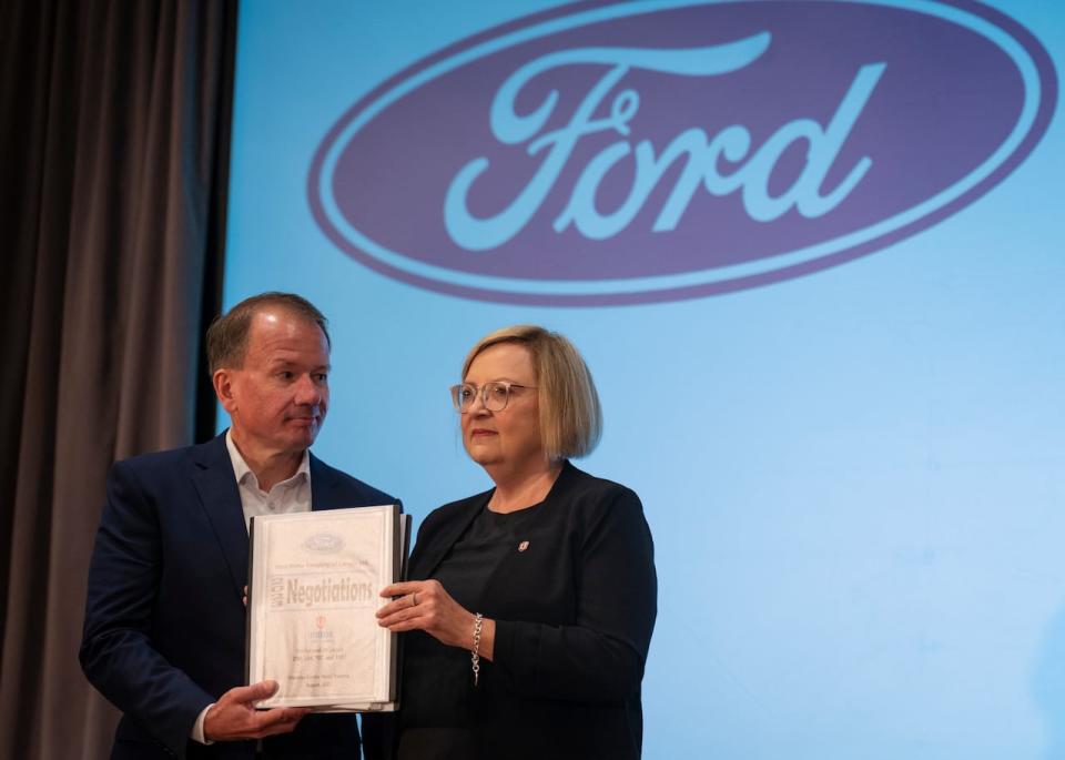 Lana Payne, national president for Unifor and Steve Majer, vice president of Ford's human resources, take part in a photo opportunity as Unifor begins formal contract talks with Detroit automakers Ford, General Motors and Stellantis in Toronto on Thursday, August 10, 2023. 