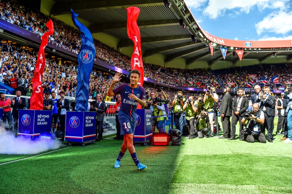 Paris Saint-Germain's Brazilian forward Neymar gestures as his arrives during his presentation to the fans at the Parc des Princes stadium in Paris on August 5, 2017.  Brazil superstar Neymar will watch from the stands as Paris Saint-Germain open their season on August 5, 2017, but the French club have already clawed back around a million euros on their world record investment. Neymar, who signed from Barcelona for a mind-boggling 222 million euros ($264 million), is presented to the PSG support prior to his new team's first game of the Ligue 1 campaign against promoted Amiens. / AFP PHOTO / ALAIN JOCARD        (Photo credit should read ALAIN JOCARD/AFP/Getty Images)