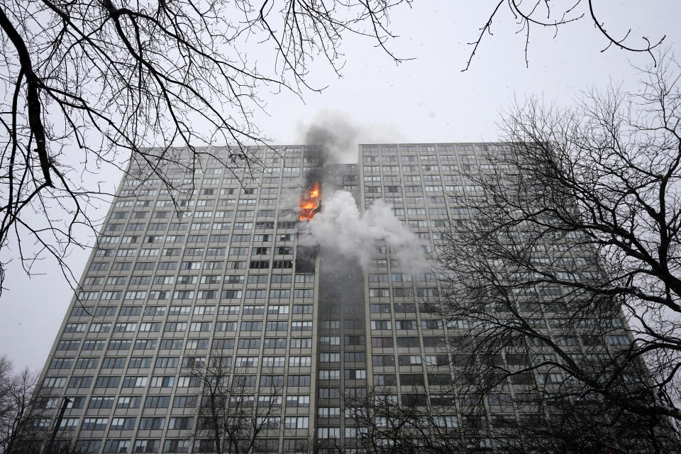 Flames leap skyward out of the Harper Square cooperative residential building in the Kenwood neighborhood of Chicago, Wednesday, Jan. 25, 2023. (AP Photo/Charles Rex Arbogast)