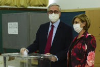 Turkish Cypriot leader and candidate Mustafa Akinci and his wife Merak Akinci cast their ballots at a polling station in the Turkish occupied area in the north part of the divided capital Nicosia, Cyprus, Sunday, Oct. 18, 2020. Turkish Cypriots are voting in a leadership runoff to chose between an incumbent who pledges a course less bound by Turkey’s dictates and a challenger who favors even closer ties to Ankara. (AP Photo/Nedim Enginsoy)