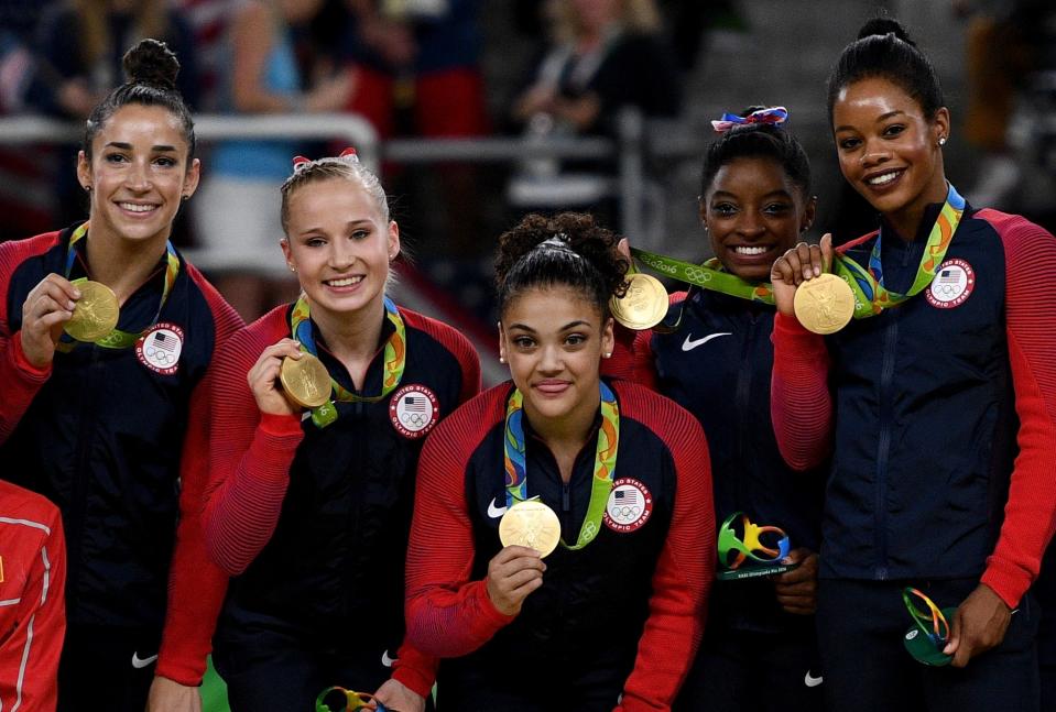 (L to R) Gold medalists Alexandra Raisman, Madison Kocian, Lauren Hernandez, Simone Biles and Gabrielle Douglas of the United States pose for photographs on the podium at the medal ceremony for the Artistic Gymnastics Women's Team on Day 4 of the Rio 2016 Olympic Games at the Rio Olympic Arena on August 9, 2016 in Rio de Janeiro, Brazil. (Photo by David Ramos/Getty Images)