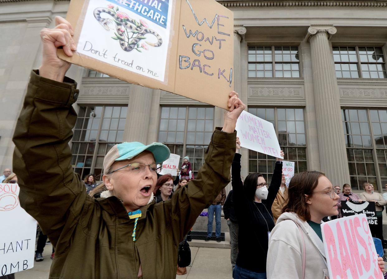 Nanci Ridder, left, of Springfield and a member of the activist group The Resistor Sisterhood, protests with others in front of the federal courthouse in Springfield to support abortion access Tuesday May 3, 2022.