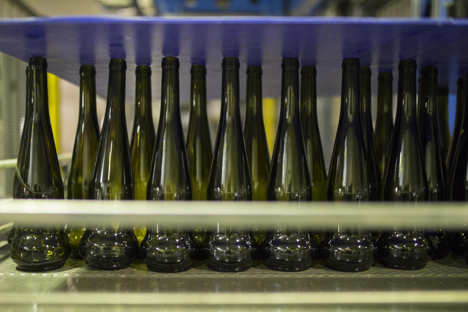 Empty wine bottles sit on a production line in the southern France region of Provence, Friday Oct. 11, 2019. European producers of premium specialty agricultural products like French wine, are facing a U.S. tariff hike on Friday, with dollars 7.5 billion duties on a range of European goods approved by the World Trade Organization for illegal EU subsidies to aviation giant Airbus.(AP Photo/Daniel Cole)