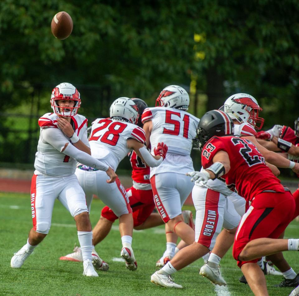 Milford High School junior quarterback Jack Buckley launches a pass against Wellesley, Sept. 15, 2023.