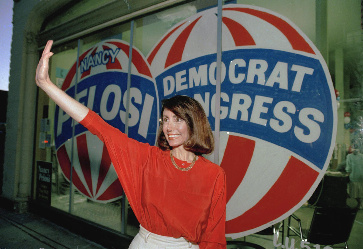 Then-Congressional candidate Nancy Pelosi waves in front of her campaign headquarters in San Francisco in 1987. (Paul Sakuma / AP file)