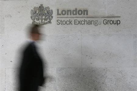 A man walks past the London Stock Exchange in the City of London October 11, 2013. REUTERS/Stefan Wermuth