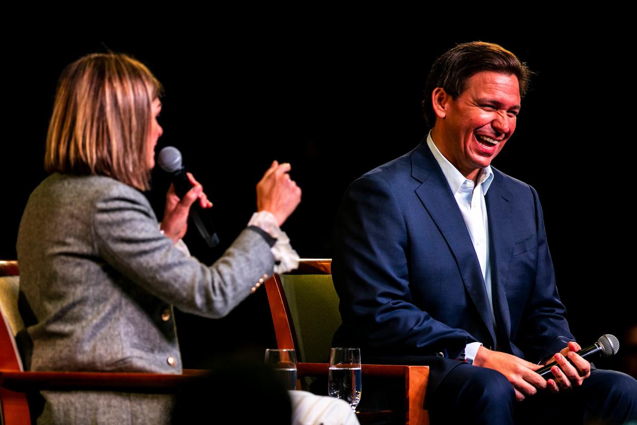 Florida Gov. Ron DeSantis speaks with Iowa Gov. Kim Reynolds during the Freedom Blueprint Event, Friday, March 10, 2023, at Rhythm City Casino Resort in Davenport, Iowa.