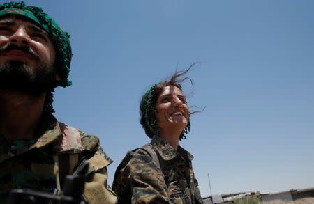 Sheen Ibrahim, Kurdish fighter from the People's Protection Units (YPG) drives in a pick up vehicle in Raqqa, Syria June 16, 2017. REUTERS/Goran Tomasevic