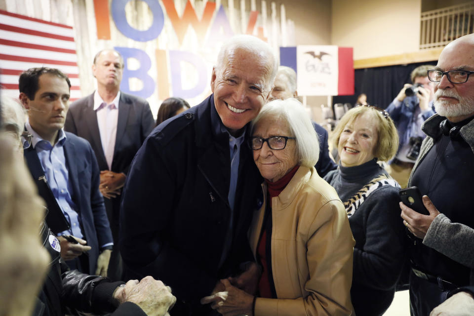 Democratic presidential candidate former Vice President Joe Biden gets a hug from Diane Burch, of Fort Dodge, Iowa, during a town hall meeting, Thursday, Oct. 31, 2019, in Fort Dodge, Iowa. (AP Photo/Charlie Neibergall)